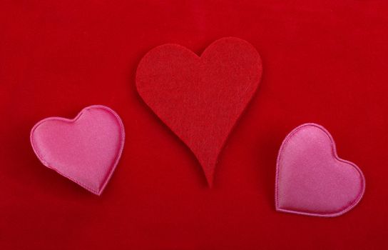 Heart decoration objects isolated on red background.