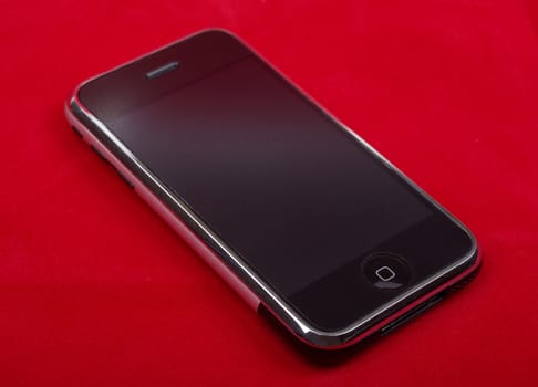 Smart phone close up isolated on red background studio shot.