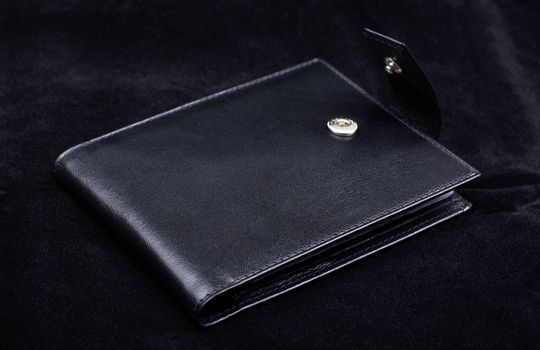 Macro of high quality wallet isolate on black velvet background.