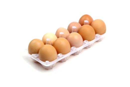 Dozen of brown eggs in plastic package isolated on white background.