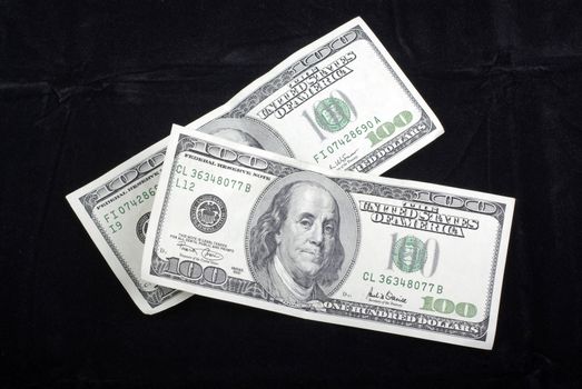 US Dollars banknotes isolated on black velvet background.