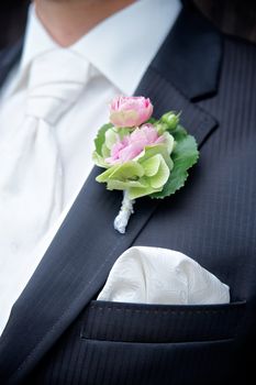 Flower on a tux of a groom with shallow depth of field