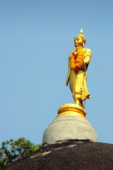 Budda on stone in bule sky sunny day.