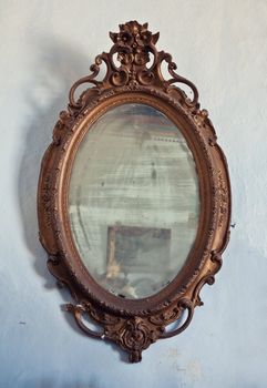 antique wooden frame on aged wall