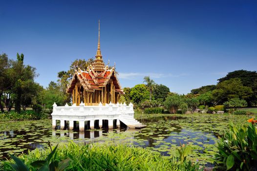 Thai pavilion in lotus pond at partly cloudy , Suan Luang Rama IX Thailand.