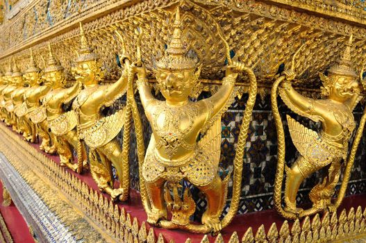 Gold ornamental patter statuettes in the Grand Palace. Temple of the Emerald Buddha, Thailand.
