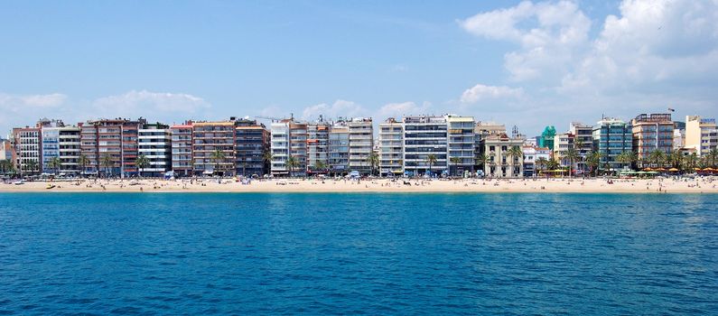 Panoramic cityscape of Lloret de Mar from sea, Costa Brava, Spain.