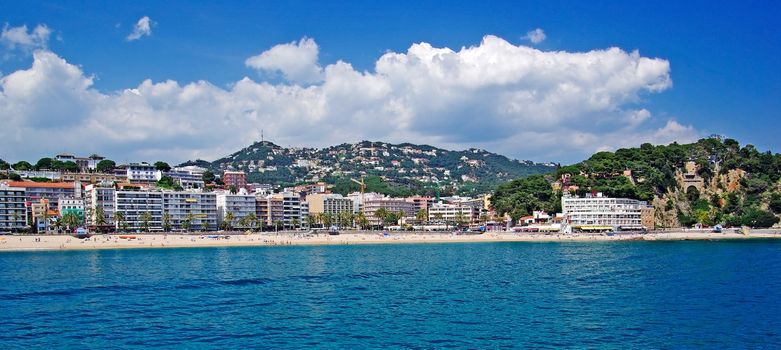 Panoramic cityscape view of Lloret de Mar from sea, Costa Brava, Spain.