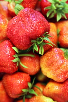 Fresh strawberry as background or wallpaper. Selective focus.