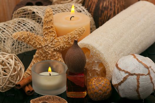 Spa concept  with aromatic candles, massage oil and loofah