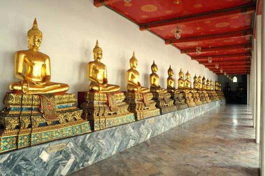 Row of the sacred Buddha image in Wat Sutad temple, Thai.