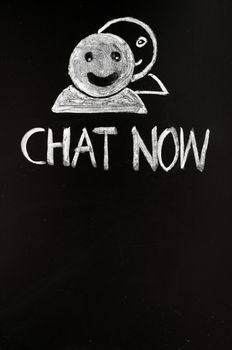 Chat online button with human figures drawn with chalk on a blackboard