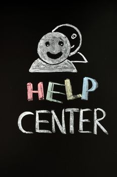 Help center with human figures drawn with chalk on a blackboard