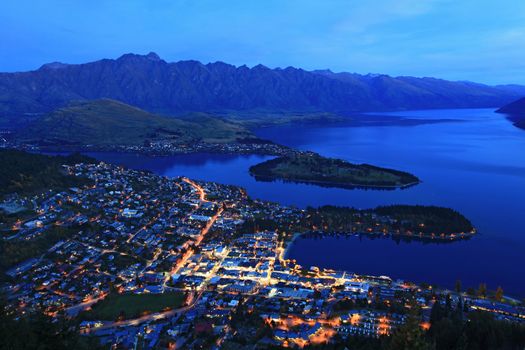 aerial view of Queenstown at dusk with the remakable range and lake wakatipu background