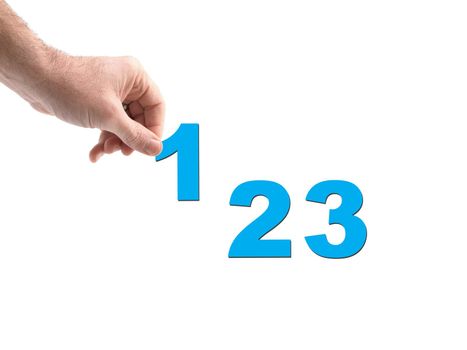 Numbers held by a hand isolated against a white background