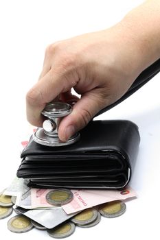 hand with stethoscope examining cash and wallet for diagnosis financial situation