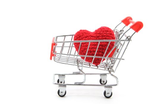 love delivery concept, red heart in Shopping cart isolated on white