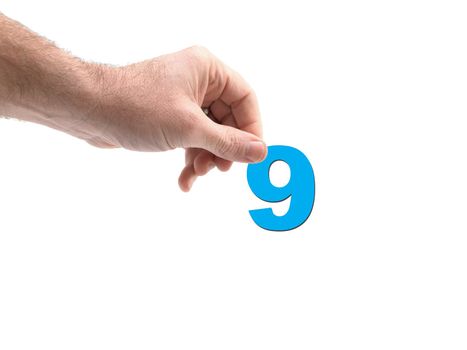 Numbers held by a hand isolated against a white background