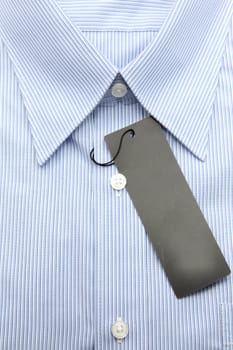 Close up view of a generic line pattern blue business shirt with a blank label