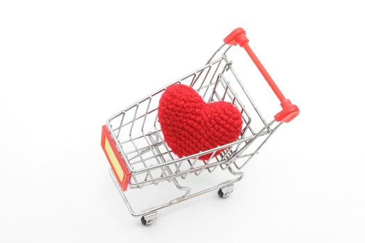 love delivery concept, red heart in Shopping cart isolated on white