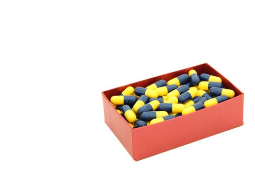 yellow blue capsules in red box