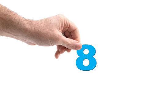 Numbers held by a hand isolated against a white background