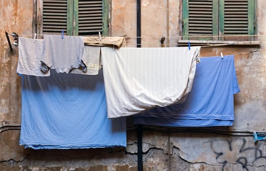 freshly washed clothes hanged on a window to dry (Rome Italy)