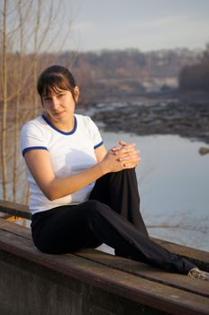 Young brunette girl walks in the park