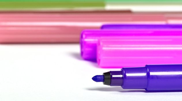multicolor markers close up on a white