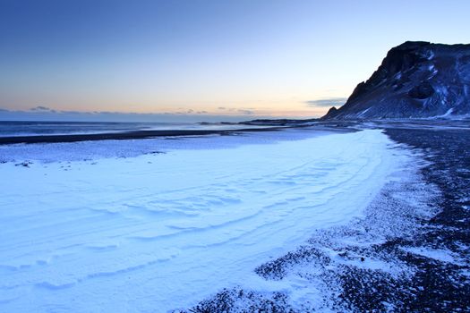 Snow settled on volcanic beach in Iceland