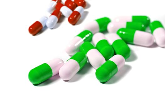 Scattered medicinal capsule isolated on white background