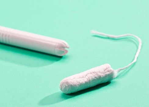 cardboard applicator tampon on white background
