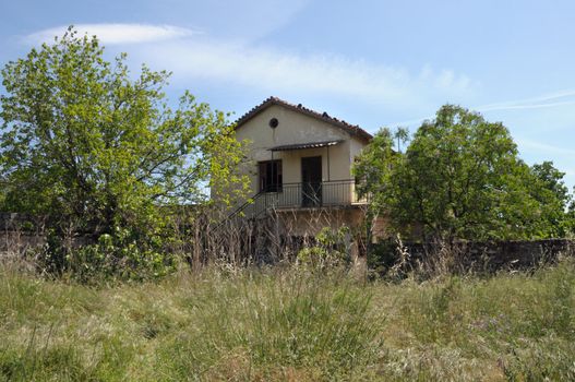 Abandoned rural house and overgrown garden.