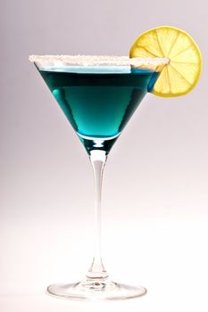 One blue cocktail martini isolated on white