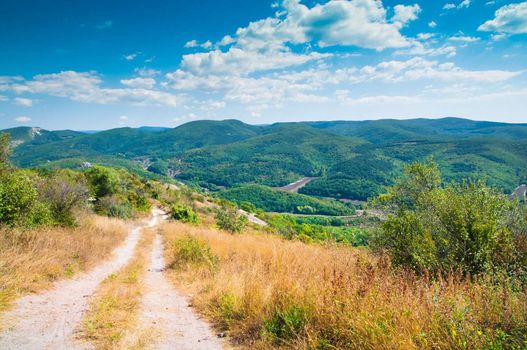 Road in mountains at blue sky