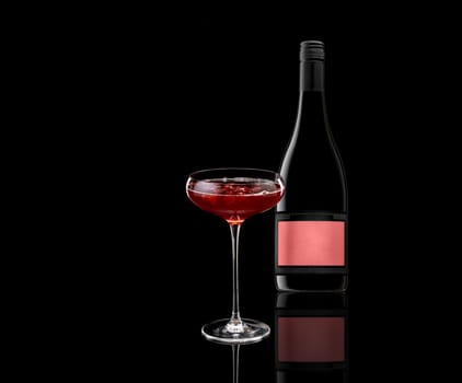 a glass of red wine and a bottle isolated on white