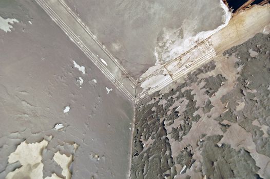 Broken ceiling and peeling wall. Abandoned house interior.