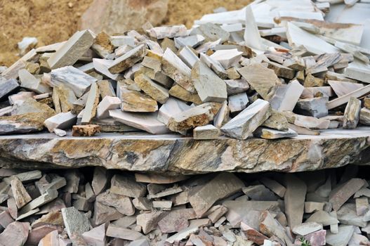 Pile of broken marble pieces from a processing factory.