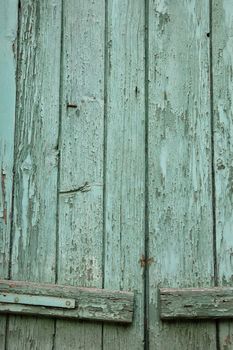 Window shutter with flaking paint. Abstract wood background.