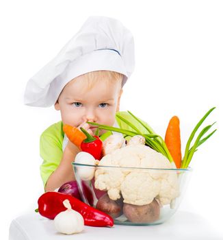 small boy with vegetables isolated on a white background