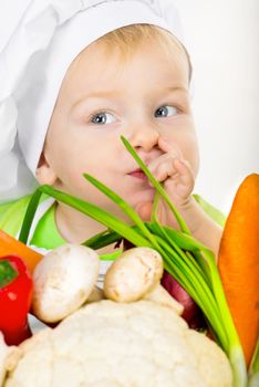 small kid with vegetables closeup