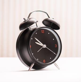 black alarm clock on light background