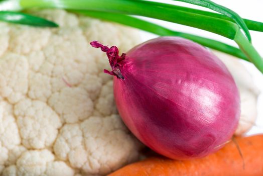 purple onion with vegetables on table closeup