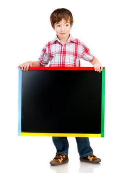 Cute boy holding a blackboard over white background