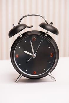 black alarm clock on light background