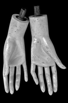 Weathered hands of plastic mannequin doll. Black and white.