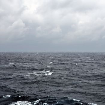Restless deep sea water and overcast sky.