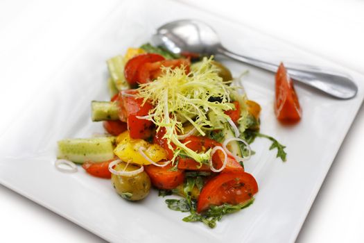 Fresh salad from tomatoes, cucumbers and an onions with olives