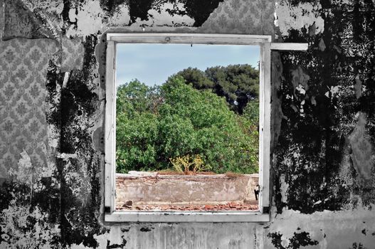 Weathered wall and window view in abandoned rural house. Selective saturation.