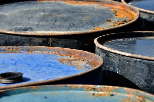 Rusty metal barrels macro. Abstract industrial background.